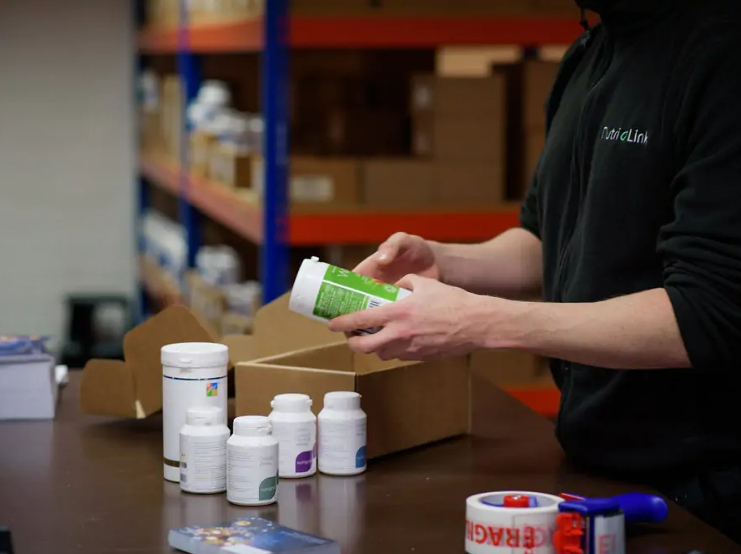 Man holding products about to pack them with care