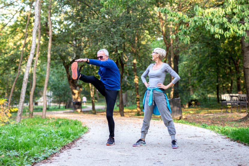 Mature couple man and woman jogging in the park