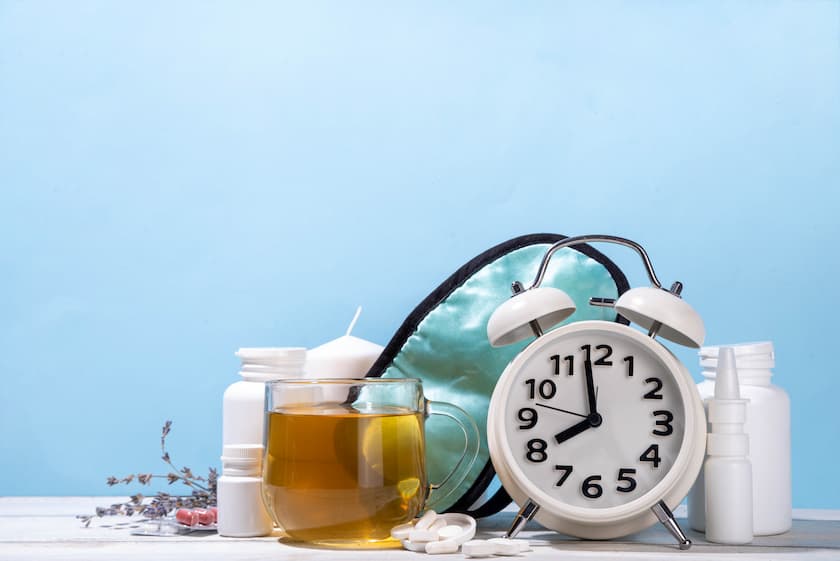 Sleepmaxxing, sleep quality improvement concept, with sleep mask, relaxing herbal tea, lavender, alternative medicine pills