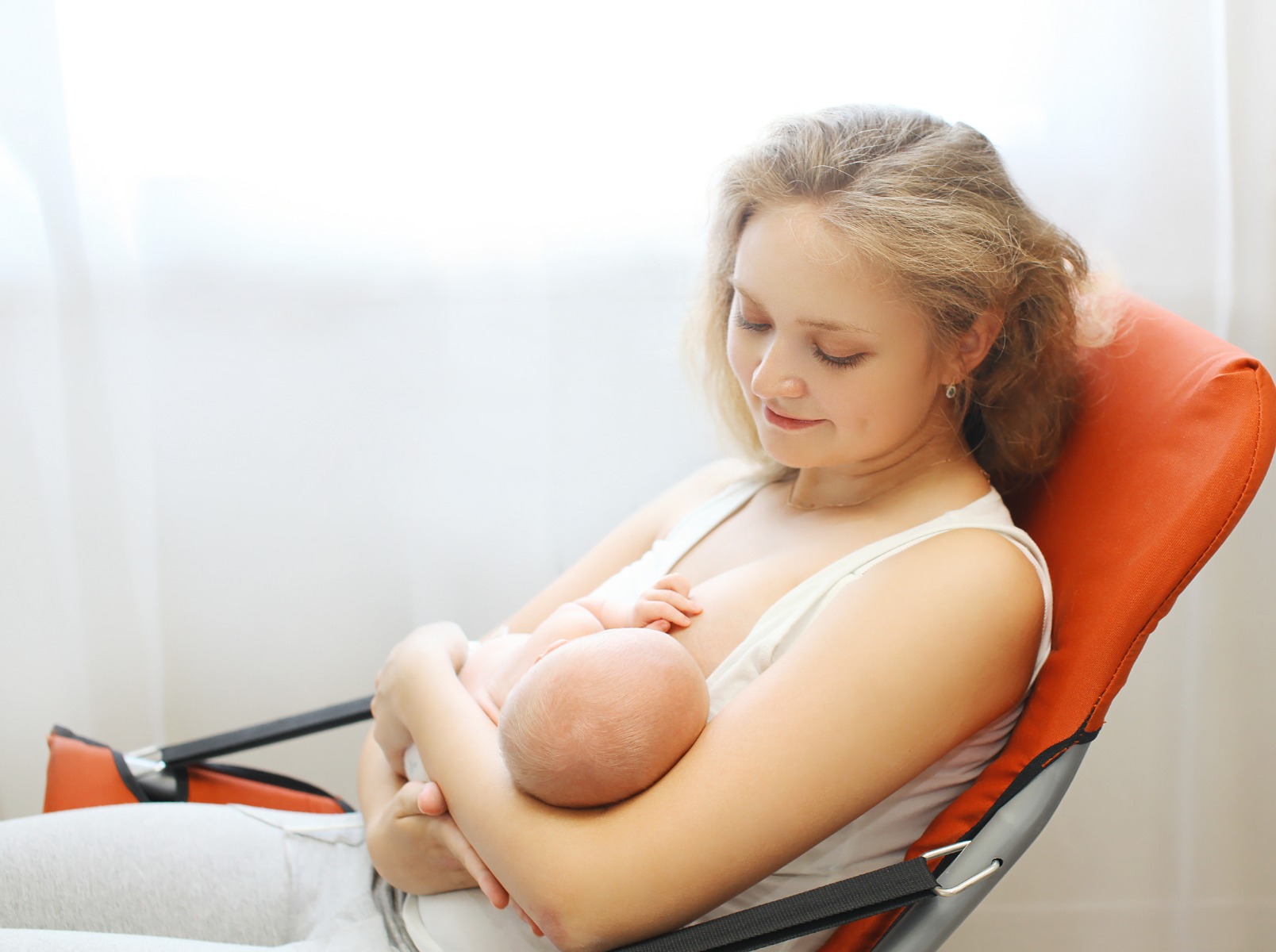 A mother breastfeeds her baby on a white background drawn image 