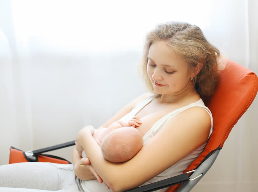 A mother breastfeeds her baby on a white background drawn image